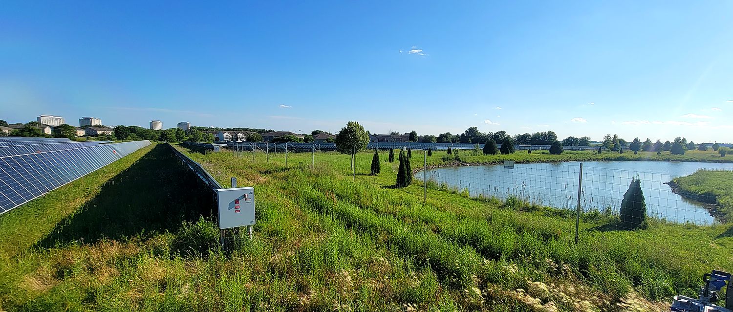 DeKalb, Illinois community solar array beside its retention pond and housing community